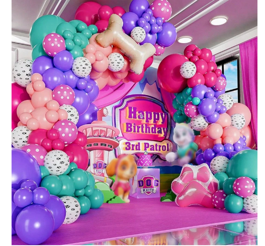 Colorful balloon arch with 'Happy Birthday' sign and cartoon character in a decorated room.