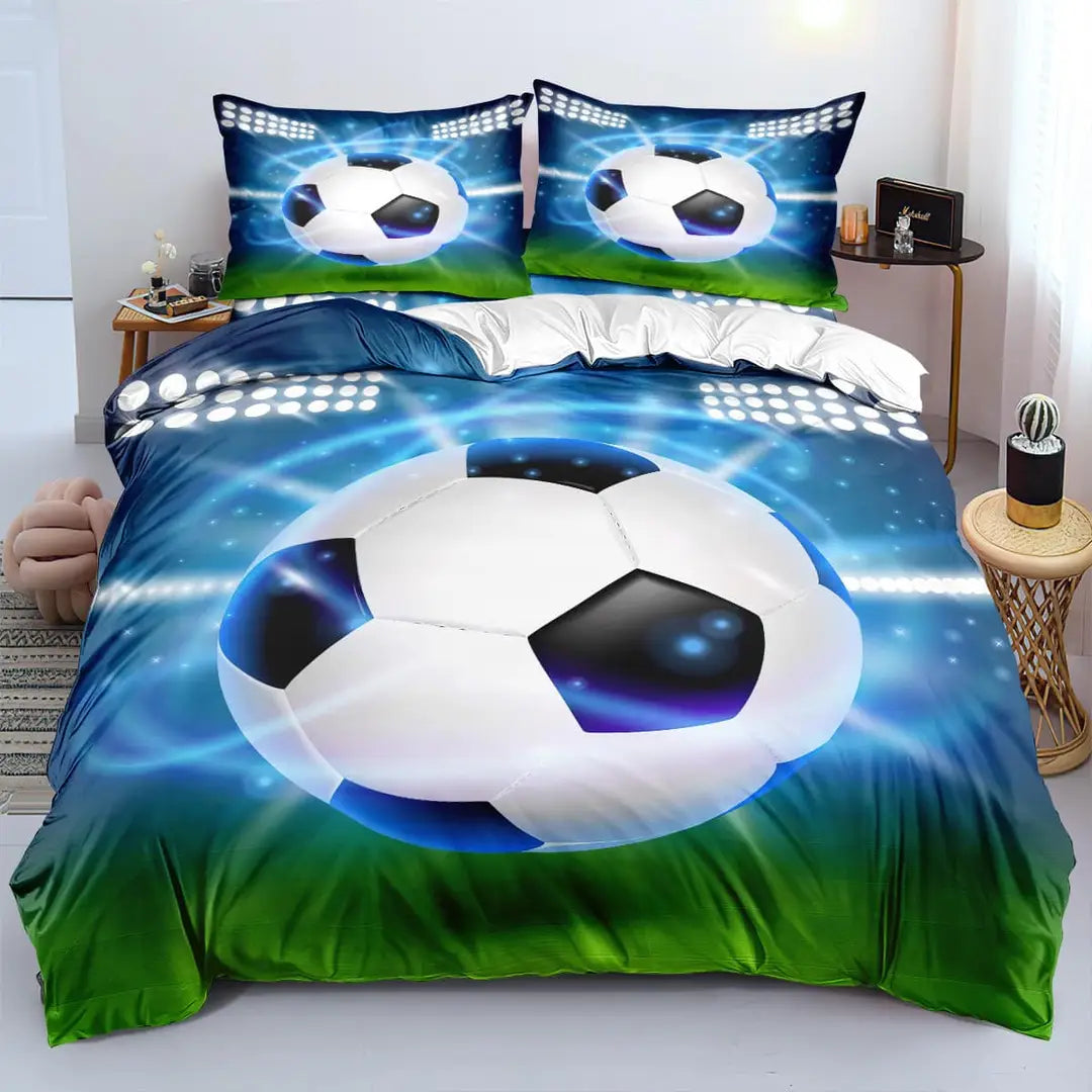 A bedding set with a soccer ball design on a bed, with a person standing beside it for scale.
