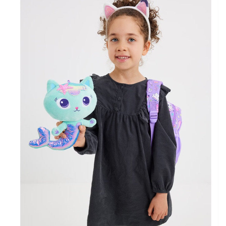 Child holding a plush toy with a white background